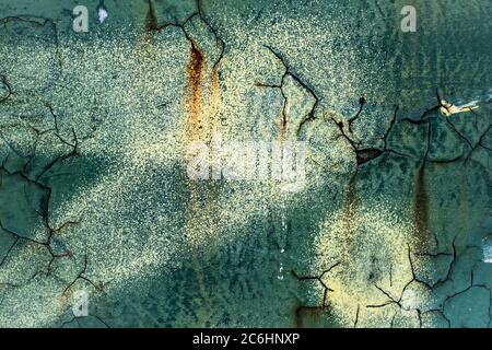 Background of peeling paint on marine blue rustic grunge wall . Stock Photo