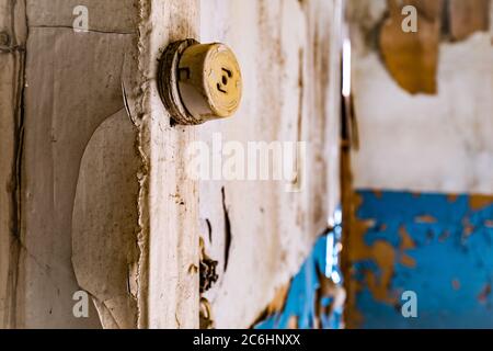 Old rusty outlet in interior of abandoned hospital building Stock Photo