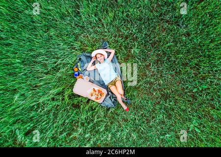 little girl on a green grass, aerial top view Stock Photo