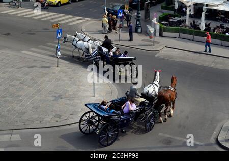 Vienna, Austria - April 24th 2011: unidentified tourists in horse drawn coach named Fiaker, a traditional sightseeing institution in Vienna Stock Photo