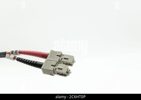 Macro image of super-fast Internet fibre optic patch leads used for high-speed, optical networking connections. Shown as a duplex pair of connectors. Stock Photo