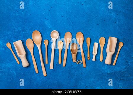 Wooden spoons on a textured classic blue background Stock Photo
