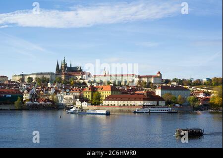 Prague Castle, Hradcany, Prague, Czech Republic / Czechia - panorama of historical part of the city. Dominant towers of Saint Vitus Cathedral. Boats w Stock Photo
