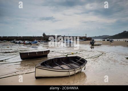 View of boats in St. Ives beach at low tide in Cornwall in England Stock Photo