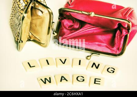 Financial concept image. Difficulty of living on low wages.  Gig economy. No savings.  words 'living wage' on tiles.  Idea shortage of cash.  povert i Stock Photo