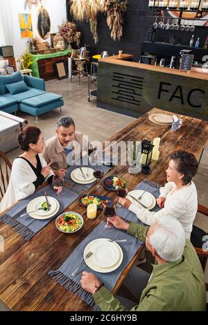 Old friends together for dinner in a restaurant Stock Photo