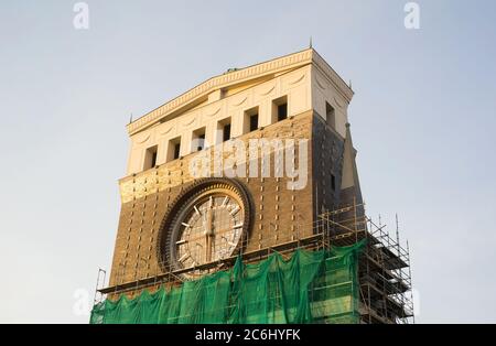 Church of the Most Sacred Heart of Our Lord, Prague Vinohrady - Frontal side of clock tower with dial. Scaffold around building. restoration of archit Stock Photo