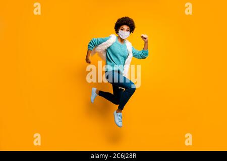 Full length body size view of her she attractive healthy active purposeful girl wearing mask jumping running stop mers cov flu grippe healthcare Stock Photo