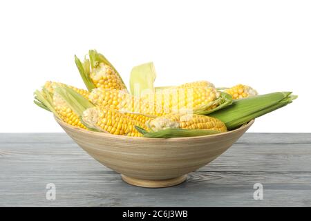 Bowl with corn on wooden table isolated on white background Stock Photo