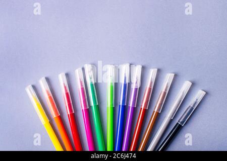 Multicolored felt-tip pens or markers on gray background. Stock Photo