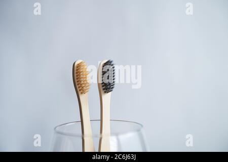 Toothbrushes in glass on blurred background Stock Photo