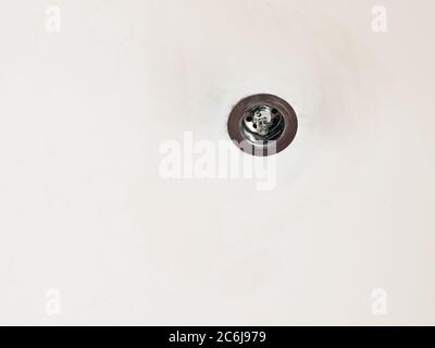used halogen lamp mounted in old plasterboard false ceiling Stock Photo