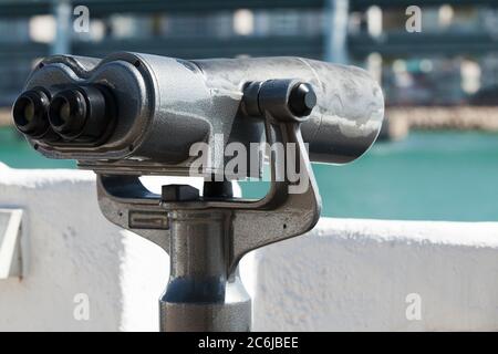 Touristic binocular telescope on a rotating base. Close up photo with selective focus Stock Photo