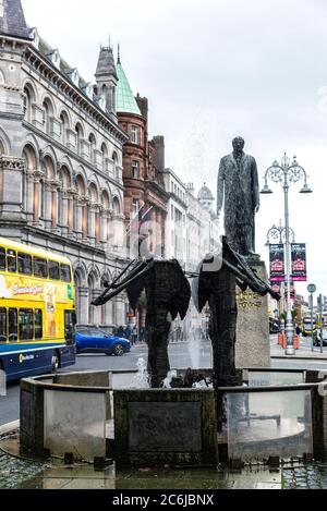 Dublin, Ireland - December 30, 2019: Thomas Davis Statue & Memorial Fountain with traffic and people around on Dame street in Dublin, Ireland Stock Photo