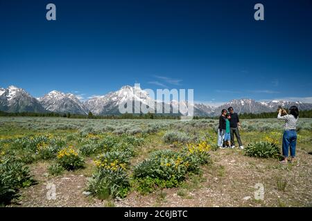 Grand Teton National Park, Wyoming - June 26, 2020: Tourist family poses for photos at a scenic pullout in the National Park on a summer day Stock Photo