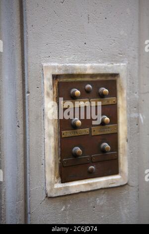 Retro intercom at building entrance. Selective focus on nameplate with Europa Club inscription in centre of image. May, 2013. Pisa, Italy Stock Photo