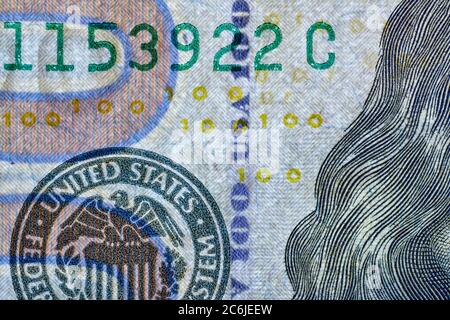 Security thread imprinted with alternating letters USA and the numeral 100 used on US$100 banknote (2009 A series) as a security feature.