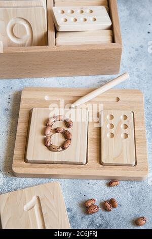 Wooden counting and writing trays - learning resource for educating littles on number writing, fine motor skills, hand eye coordination, mathematical Stock Photo