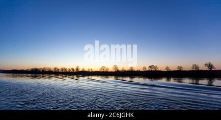 Cruising through Germany along the Blue Danube River at sunrise. Stock Photo