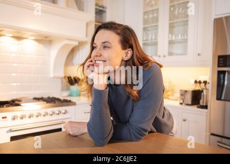Woman smiling in the kitchen Stock Photo
