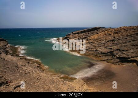 Secret beach in El Medano, long exposure, Volcanic rocks formation eroded by the wind and sea, Tenerife, Canary islands, Spain Stock Photo
