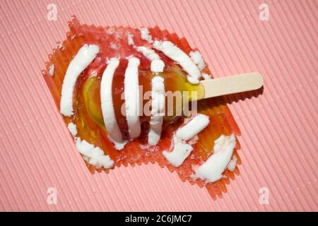 Melting Twister ice lolly on pink background Stock Photo