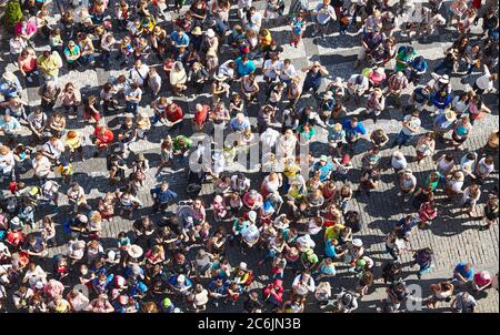 Prague, Czech Republic - June 12, 2014: Crowd of tourists gathered on the Old Town Square to watch Astronomical Clock seen from the clock tower. Stock Photo