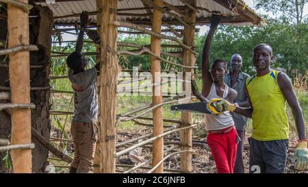 Locals take part in the construction of a new home for widow and her children Stock Photo