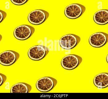 Seamless pattern. slices of dried orange a yellow background. Rustic, Mediterranean, Holiday spices ingredients /objects Stock Photo