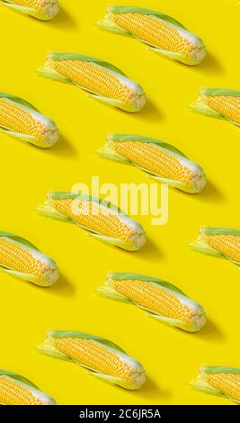 Seamless pattern. ear of fresh corn on yellow background Stock Photo