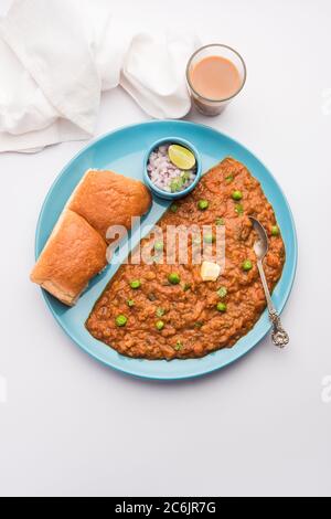 Mumbai Style Pav bhaji is a fast food dish from India, consists of a thick vegetable curry served with a soft bread roll, served in a plate Stock Photo