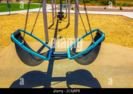 Dual Seats On Modern Swing Set In Free Public Park Stock Photo