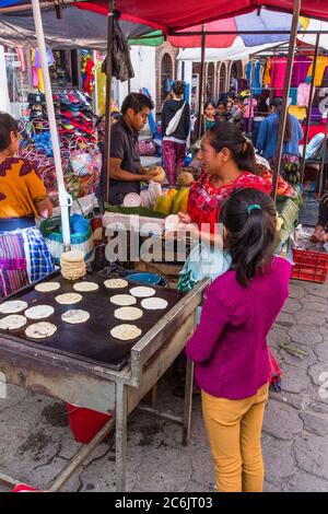 Guatemala, El Quiche Department, Chichicastenango, A Quiche Mayan woman makes tortillas in a food stall at the Indian market. Stock Photo