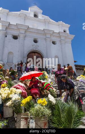 Guatemala, El Quiche Department, Chichicastenango, Vendors sell flowers on the steps of the Church of Santo Tomas. The church was built about 1545 A.D. on the platform of a Mayan pyramid. Stock Photo