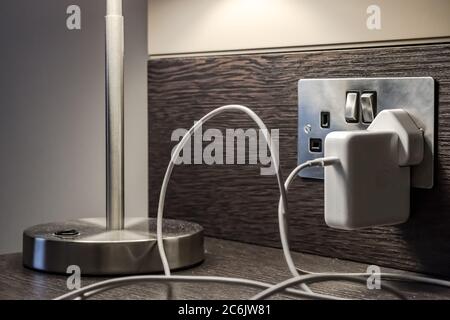 A table lamp plugged into a wall socket in the UK Stock Photo - Alamy