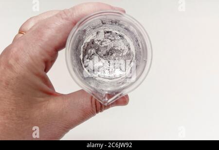 The element Gallium melting in a hand in the lab Stock Photo - Alamy