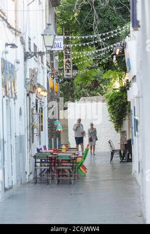 Cadaques, Spain : 07 JULY 2020 : People in the beach and houses of the village of Cadaques, Spain in summer on 07 july 2020. Stock Photo