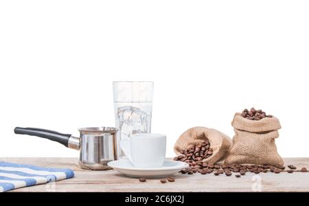 Coffee copper, cup and water. Greek coffee with pot and sacks full of coffee beans. Turkish coffee pot, white cup and pouch with beans. Isolated on wh Stock Photo
