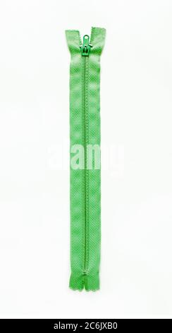 Green zipper isolated on white background. Stock Photo