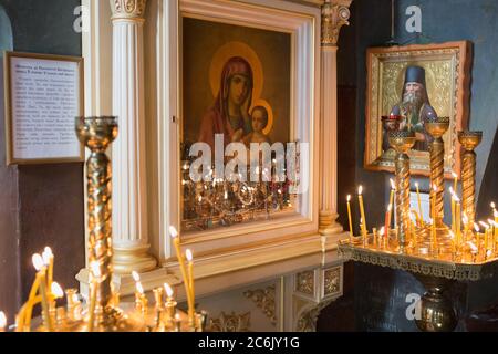 Icon of Mother of God and burning candles in church of St. Peter's Basilica. Close up shot. Large Christian Catholic Cathedral of the Vatican. May Stock Photo