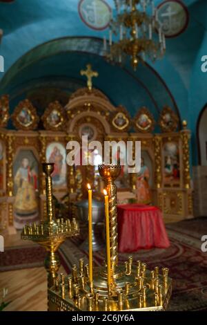 Burning candles before Iconostasis in church Interior. St. Peter's Basilica, large Christian Catholic Cathedral of the Vatican. May, 2017 - Rome Stock Photo