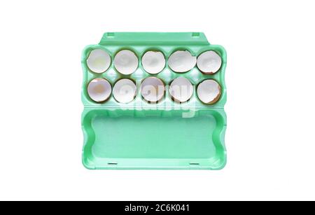 Green egg carton/container with cracked egg shells isolated on white background Stock Photo