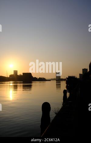 Silhouette of modern buildings on the river IJ in the summer just before sunset in Amsterdam the Netherlands Stock Photo