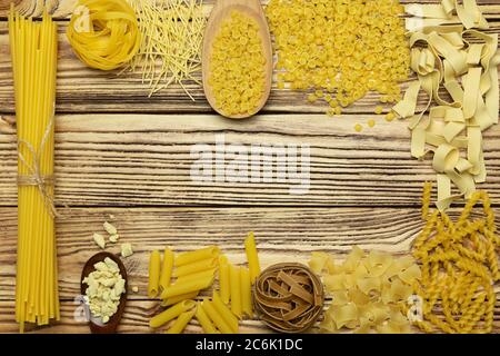 Italian whole grain pasta on a wooden background. Stock Photo