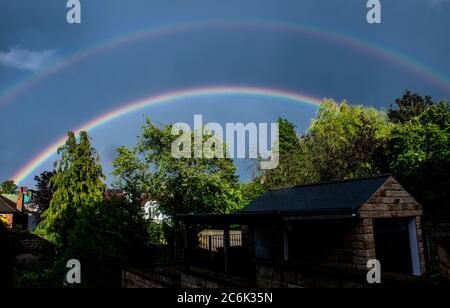Harrogate, North Yorkshire, UK. 10th July, 2020. After a day of alternated sunshine and rain, a full double rainbow appeared over Harrogate only for a few seconds. Credit: ernesto rogata/Alamy Live News Stock Photo