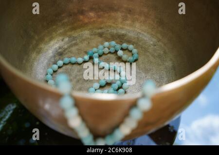 Tibetan singing bowl close up with beautiful turquoise Mala for soundhealing