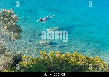 Beautiful view from an aegean coast. Large copy space. Meeting point of green and blue. Stock Photo