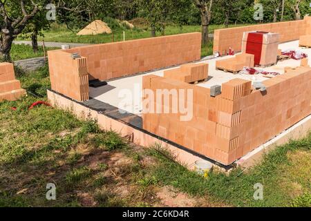 Construction of a small family house. House construction site. Brick wall on a construction site. A new house. Stock Photo