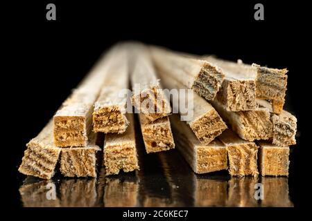 Raw slats prepared for further processing. Material in a home carpentry. Dark background. Stock Photo