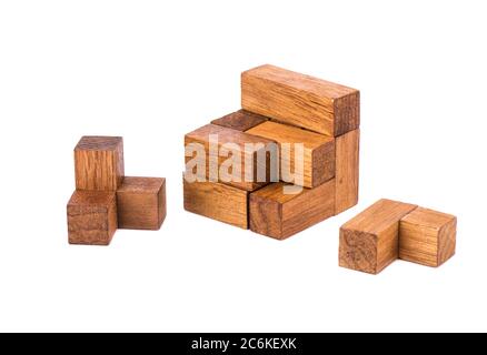 Disassembled puzzle cube 7. Wooden puzzle consisting of 7 parts isolated on a white background. Copy space. Stock Photo